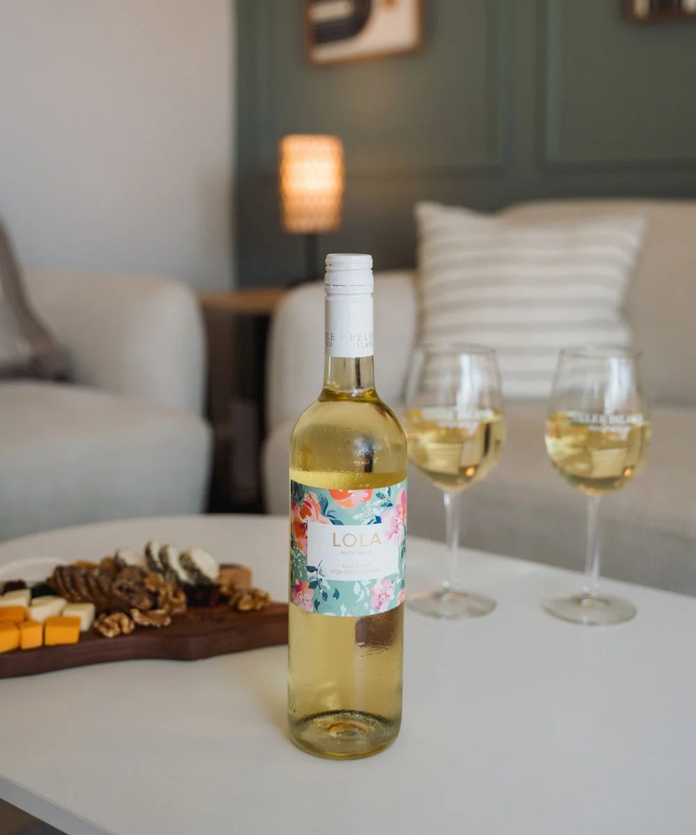 LOLA Pinot Grigio with Two wine Glass and a charcuterie