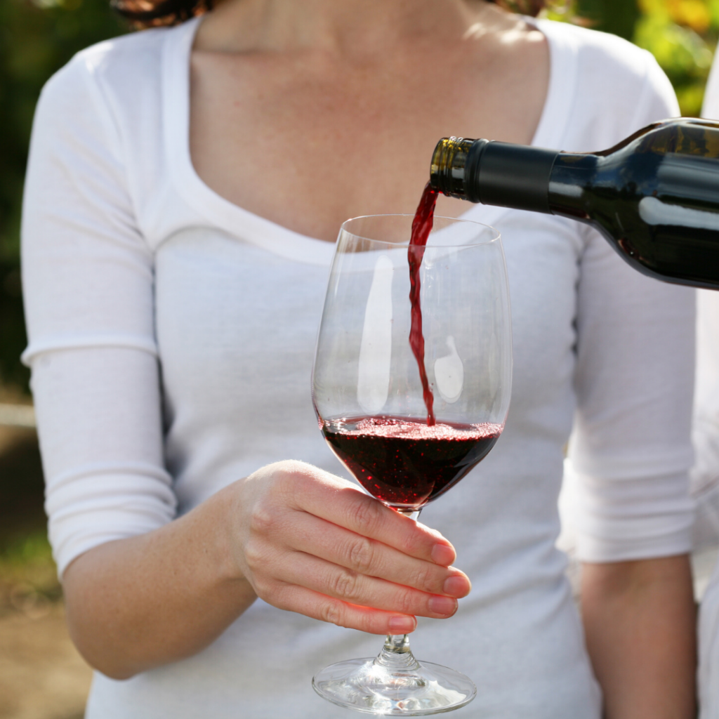 Pouring a glass of Pelee Island Winery red wine VQA into a glass.