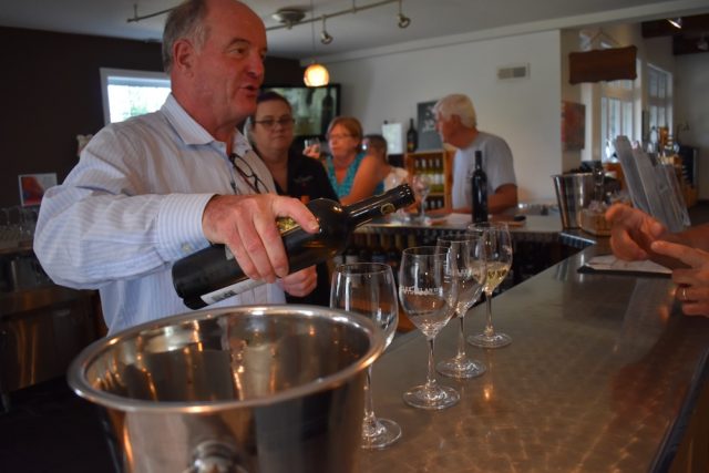Pelee Island Winery President, Walter Schmoranz, pouring wine at the Pelee Island Winery tasting bar. Learn more about us on this page