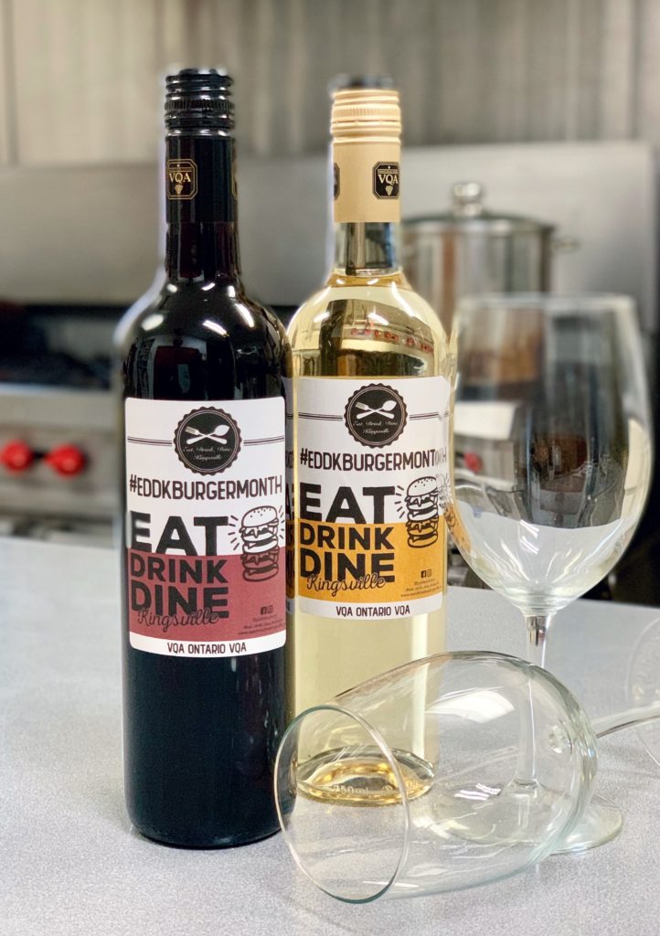 Pelee Island Winery Pinot Grigio and Cabernet Franc VQA exclusive labeled bottles for Eat Drink Dine Kingsville's Best Burger Month on restaurant kitchen with two wine glasses
 