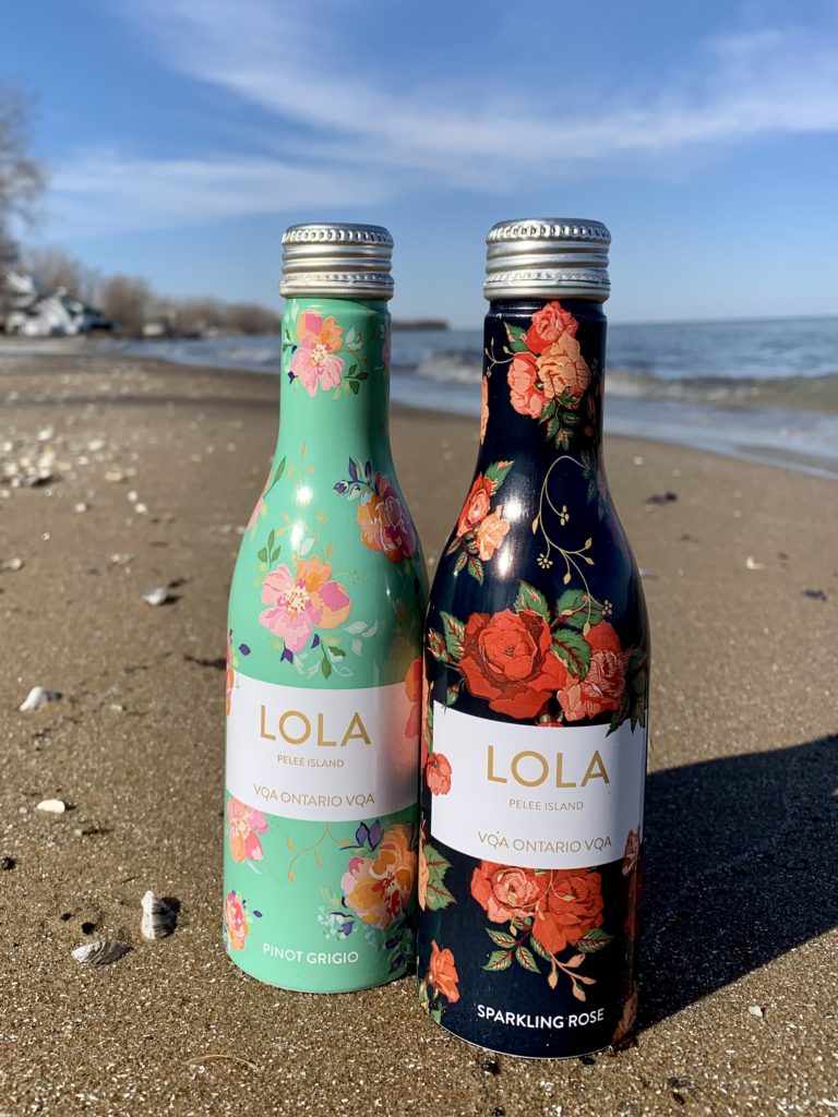 LOLA aluminum 250mL bottles with LOLA Pinot Grigio VQA Ontario white wine and LOLA Blush Sparkling Rosé VQA Ontario wine for picnic season on beach.