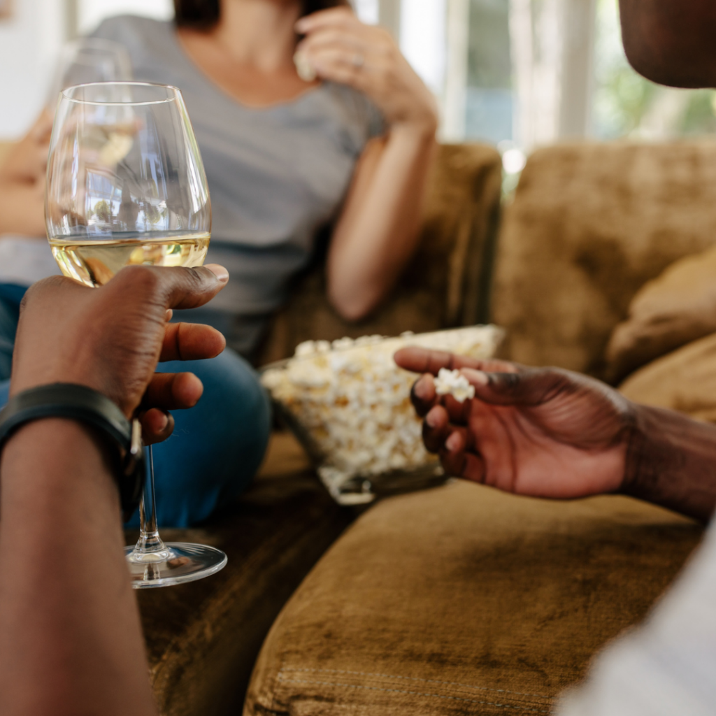 Wine & Movie Guide watching movie with popcorn and wine