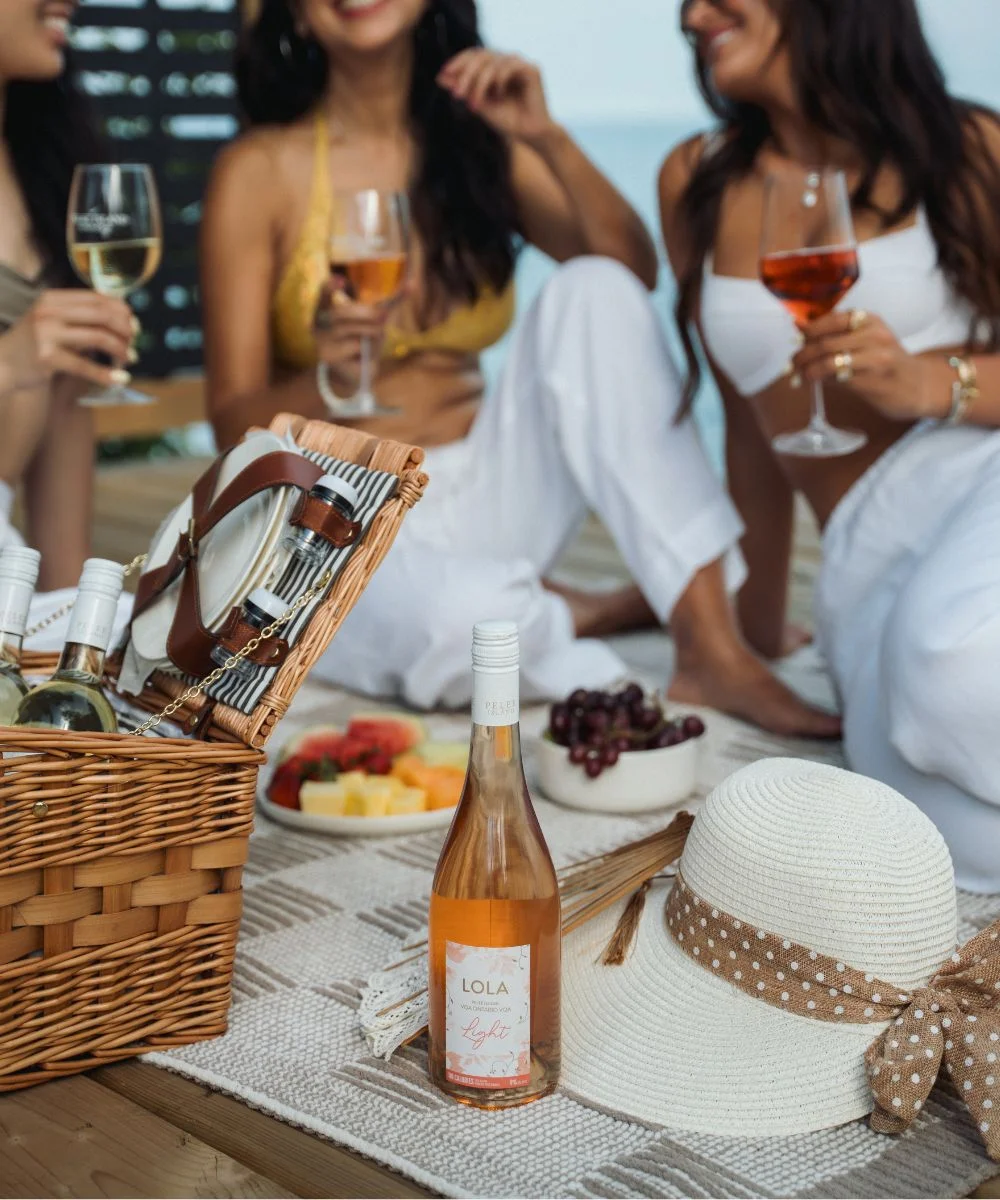 Bottle of LOLA Ligt Rose with Three Ladies picnic